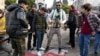 Syrians step on a regime flag as they celebrate near the Clock Tower in the central city of Homs on December 8.