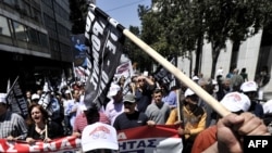 Demonstrators shout slogans near the Greek parliament building during a protest in Athens on May 4.