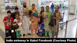 A family of Afghan Sikhs prepares to leave Kabul for India in July 2020.