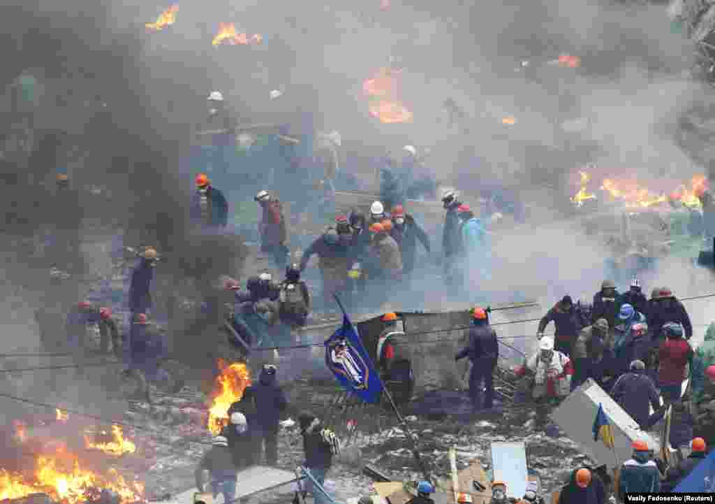 Protesters carry an injured man.