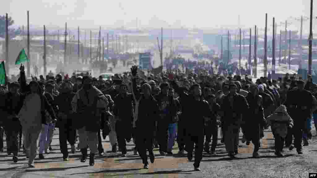 Afghan demonstrators run as they shout anti-U.S. slogans during a protest against Koran desecration in Kabul on February 23.