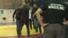 A screen grab from a YouTube video appears to show a man brandishing a gun during a melee that broke out during a wrestling match in Russia.