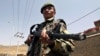 A member of the Afghan security forces stands guard on a roadside after security was increased following reports of Mullah Omar's death.