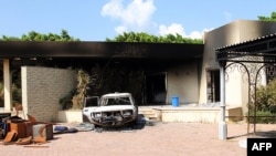 A burnt house and a car are seen inside the U.S. diplomatic compound in Benghazi, Libya, which was attacked by Islamist militants last year.