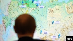 Russian President Vladimir Putin looks at a Russian map during the live broadcast of a rocket test-launch in December.