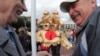 Two people in a costume depicting the Russian state symbol of a double-headed eagle take part in a rally in St. Petersburg calling for opposition candidates to be registered for elections to Moscow's city council. 