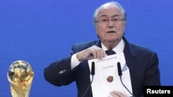 Happier days: FIFA President Sepp Blatter announces Russia as the host nation for the soccer World Cup in 2018. The raft of arrests in Switzerland has now put this decision in the spotlight.