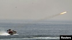 An Iranian boat fires a missile as it takes part in a naval war game in the Persian Gulf and the Strait of Hormuz.