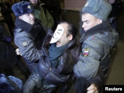 Russian police officers detain an activist during a copycat Occupy protest in central Moscow on November 7.