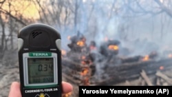 Emergency workers test radiation levels in the Chernobyl exclusion zone on April 5.