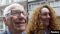 News Corporation CEO Rupert Murdoch leaves his flat with Rebekah Brooks, chief executive of News International, in central London on July 10.