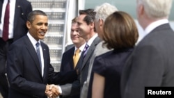 U.S. President Barack Obama greets members of an official welcoming party as he arrives in Toronto for the G8 and G20 Summits.