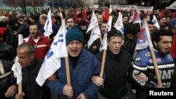 Demonstrators from the communist-affiliated trade union PAME march to parliament in protest against the new austerity measures in Athens on February 7.