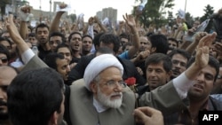 Mehdi Karrubi (center) has led calls for the complaints of the rape of prisoners detained in the demonstrations following the election to be investigated.