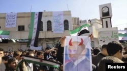 Demonstrators rally against Syrian President Bashar al-Assad after Friday Prayers in Talbiseh, Syria