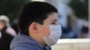 A child in Pristina wears a mask to protect against coronavirus.