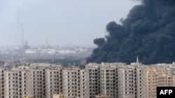 A thick plume of smoke rises above an oil refinery, situated to the west of the flashpoint city of Homs, following the blast on December 8.