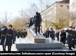 A monument in Chita, in Russia's Far East, depicts a fighter of Russia's invasion carrying a girl. Behind the modern soldier, there is a shadow-like depiction of a Soviet soldier similarly holding a child.