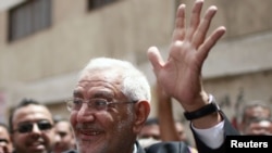 Presidential candidate Abdel Moneim Abul Fotouh waves after casting his vote at a polling station in Cairo. A Fotouh presidency could present a challenge to the ruling military council.