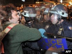 A protester is confronted by New York police officers as authorities cleared Zuccotti Park.