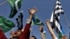 Supporters of Islamic parties hold party flags and shout slogans as they demand punishment for Aasia Bibi, the Christian woman sentenced to death for blasphemy, at a rally in Karachi last month.