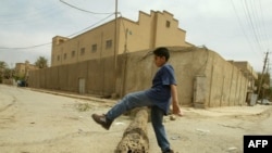 An Iraqi boy plays in front of a closed synagogue in Baghdad. Only a few Jews remain in Iraq today.