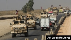 A convoy of U.S. vehicles is seen after withdrawing from northern Syria, on the outskirts of Dohuk, Iraq, on October 21.