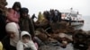 Migrants arrive on the Greek island of Lesbos on an overcrowded fishing boat after crossing the Aegean sea from Turkey.