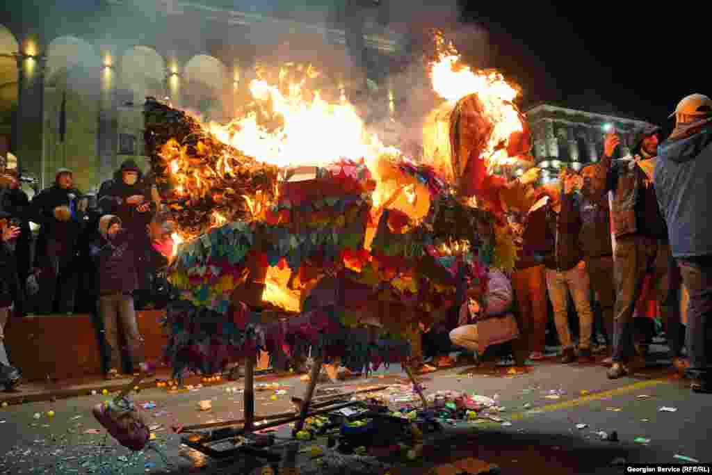 Protesters burn a pinata depicting Georgia&#39;s riot police chief Zviad Kharazishvili on Rustaveli Avenue on February 18.&nbsp;