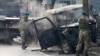 Turkish soldiers take pictures of a vehicle at the site of a suicide attack in Kabul. (file photo)