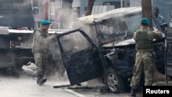 Turkish soldiers take pictures of a vehicle at the site of a suicide attack in Kabul. (file photo)