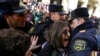 Police officers block activists during a rally held to support women's rights and to protest against violence toward women on International Women's Day in Baku on March 8.