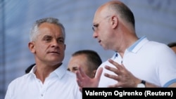 Moldova's Democratic Party (PDM) says the government of Prime Minister Pavel Filip (right) is resigning, signaling that a standoff with an incoming coalition cabinet is coming to an end. He's shown here with the leader of the Democratic Party of Moldova, Vladimir Plahotniuc.