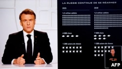 President Emmanuel Macron addresses the nation on live TV, with a graphic outlining a projection of Russia's military strength shown onscreen on March 5.