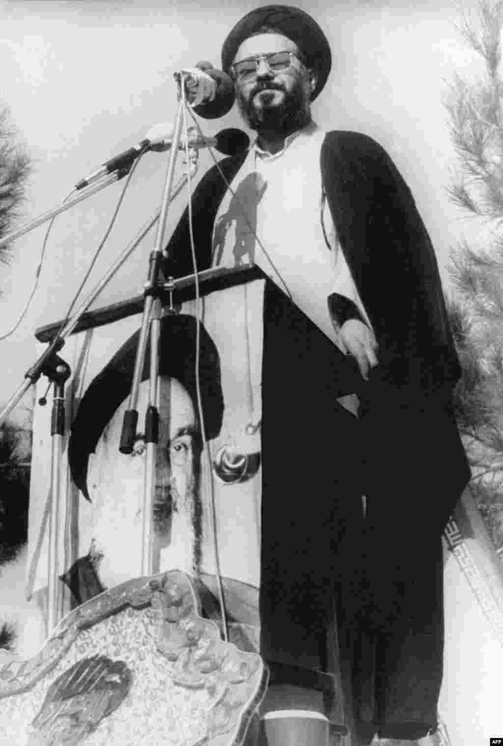 Student leader Ayatollah Musavi Khoeniha speaks from the top of a U.S. Embassy wall on the siege&#39;s first anniversary. 