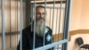 Andrei Vinarsky in the defendants cage in a court in Khabarovsk on May 13. 