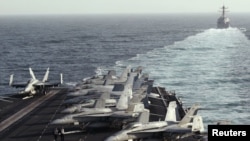 The U.S. destroyer "Sterett" escorts the Nimitz-class aircraft carrier "USS Abraham Lincoln" during a transit through the Strait of Hormuz in February.