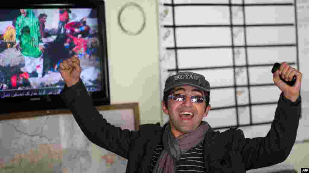 Agence France-Presse (AFP) photographer Massoud Hossaini reacts as the prizewinning photograph is shown on Afghan television on April 17. (AFP/Johannes Eisele)