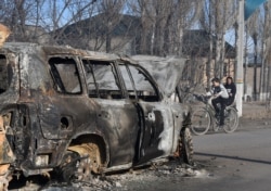 Бұлар батыр ауылындағы өртенген автокөлік қаңқасының қасынан өтіп бара жатқан балалар. Жамбыл облысы, 8 ақпан 2020 жыл.