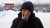 The mother one of the miners who died in the November 25 accident reacts at the entrance to the Listvyazhnaya coal mine in the Kemerovo region. 