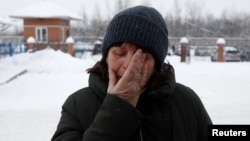 The mother one of the miners who died in the November 25 accident reacts at the entrance to the Listvyazhnaya coal mine in the Kemerovo region. 