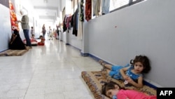 Syrian children, whose families have fled clashes between rebels and regime forces in Damascus and Homs, lie on a mattress at a school where refugees have taken shelter in the neighborhood of Mazzeh.