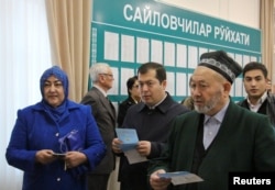 People wait to vote at a polling station in Tashkent on December 4.