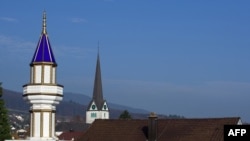 A minaret installed on the roof of a Turkish cultural center in Switzerland.