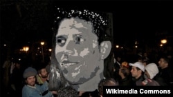 Tunisians hold up a portrait of Mohammed Bouazizi, whose death after he set himself on fire triggered the chain of popular uprisings in North Africa that became known as the Arab Spring