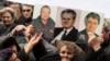 Nationalists hold up pictures of Ratko Mladic, Radovan Karadzic, and Slobodan Milosevic at a rally in 2007. Now they are rallying for Libya's Muammar Qaddafi.