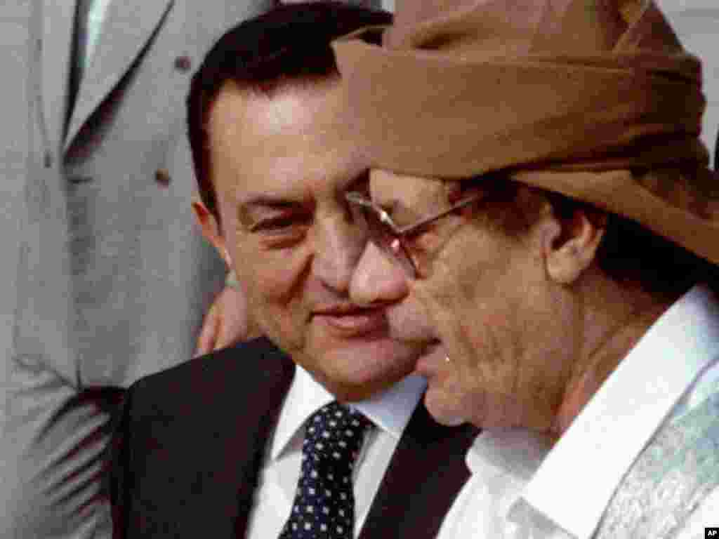 Qaddafi chats with Egyptian President Hosni Mubarak upon his arrival in Cairo on June 22, 1996, to attend an Arab Summit. Mubarak was himself ousted as president by antigovernment protests in February and is now on trial in Cairo.