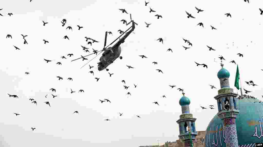 An Afghan National Army helicopter flies over the Sakhi Shrine in Kabul in March.