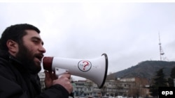 Demonstrators rally outside Imedi television station in Tbilisi on March 14, the day after the hoax broadcast.