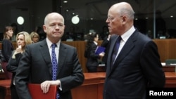 British Foreign Secretary William Hague (left) talks to Dutch Foreign Minister Uri Rosenthal at the start of a EU foreign ministers meeting at the EU Council headquarters in Brussels.